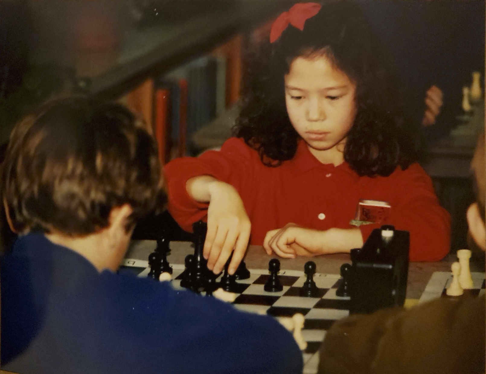 Katie playing chess as a young girl